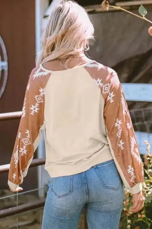 Back view of cream Western Print Long Sleeve Top with brown tribal sleeves, perfect for relaxed seasonal outfits.