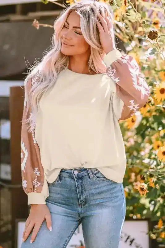 Western Print Patch Long Sleeve Top in cream with brown Aztec sleeves, styled with jeans for a casual outdoor fall look.