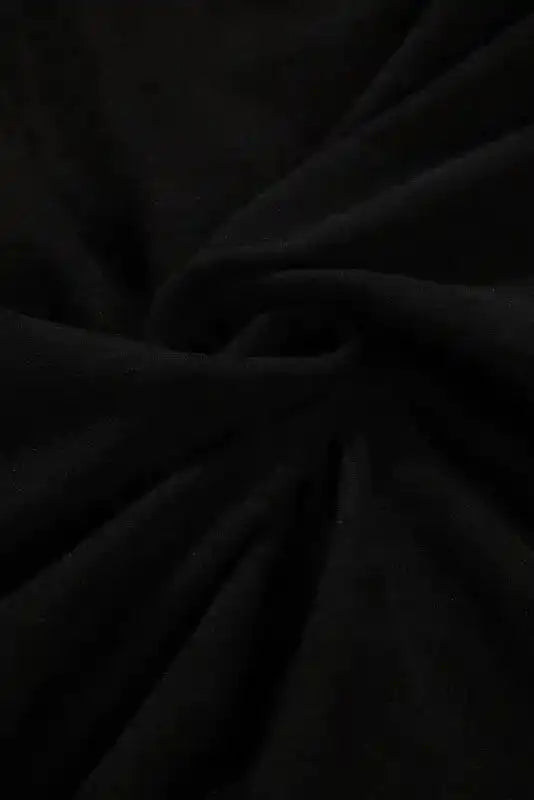 Close-up of soft black fleece fabric used in the Western Print Patch Long Sleeve Top, emphasizing its cozy winter material.