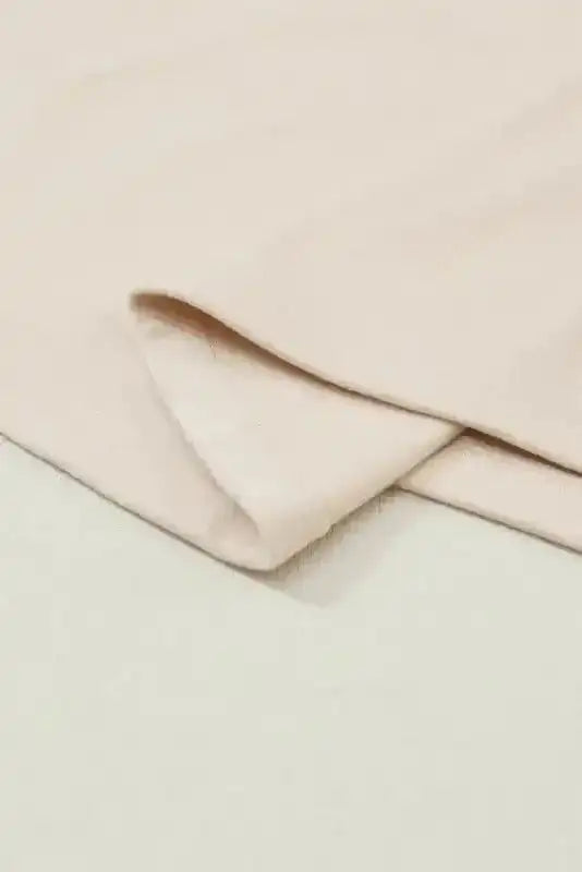 Detail shot of the hem and stitching on the Western Print Long Sleeve Top, showcasing quality fleece fabric and craftsmanship.
