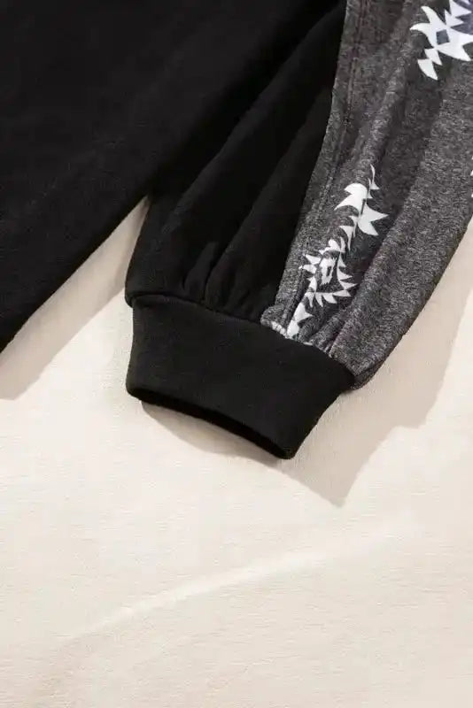 Cuffed sleeve detail of the Western Print Long Sleeve Top with Aztec pattern, adding a stylish touch to the casual design.
