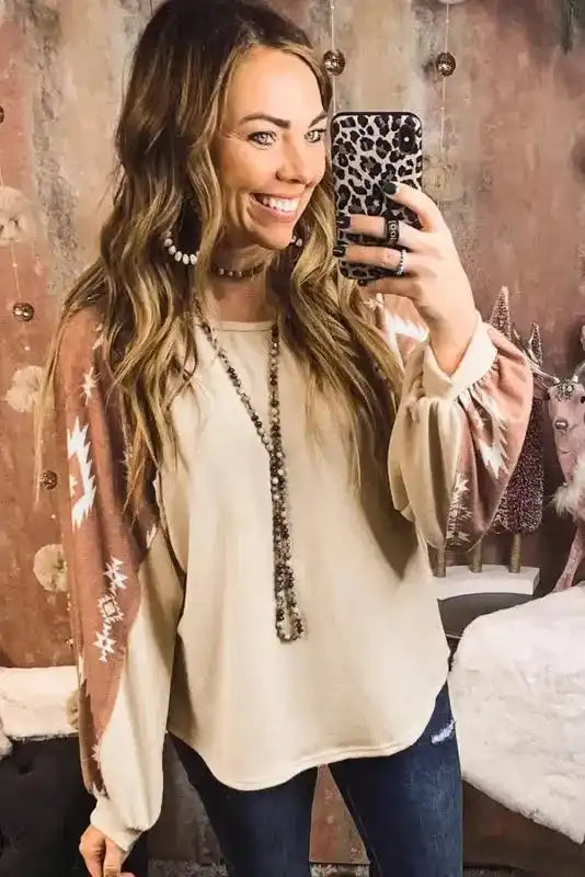 Western Print Long Sleeve Top styled with accessories, highlighting the cozy fleece fabric and bold Aztec sleeve pattern.