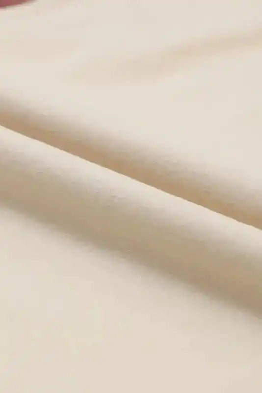 Close-up of beige fleece fabric used in the Western Print Long Sleeve Top, highlighting its soft and cozy texture.