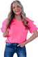 Smiling woman with long blonde hair in a bright pink whimsical wave blouse and blue jeans