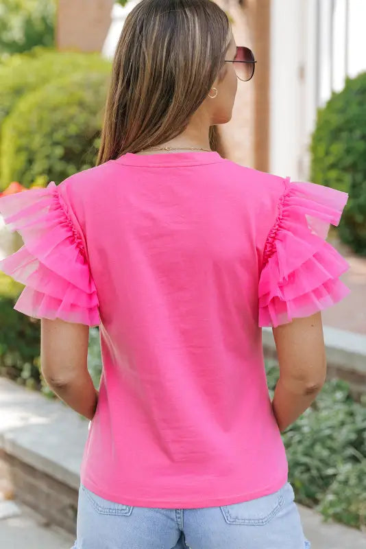 Whimsical wave blouse: bright pink t-shirt with ruffled tulle sleeves. Relax relax relax!