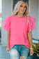 Bright pink whimsical wave blouse with ruffled sleeves worn with distressed blue jeans