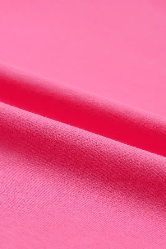 Vibrant pink fabric with soft folds on the whimsical wave blouse for a relax-relax vibe