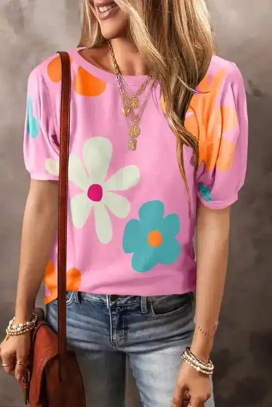 Women's floral bubble sleeve tee in pink, apricot, and black – puff sleeves, round neckline, summer fashion.
