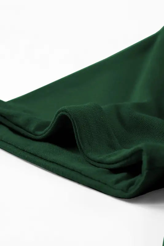 Dark green fabric with folds on a white casual plain crew neck t-shirt for relax relax vibes