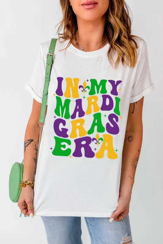 White crew neck t-shirt with colorful ’in my mardi gras era’ text and fleur-de-lis symbols