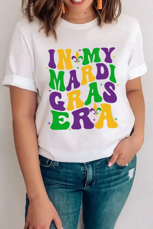 White crew neck t-shirt with ’in my mardi gras era’ text in colorful design and fleur-de-lis symbols