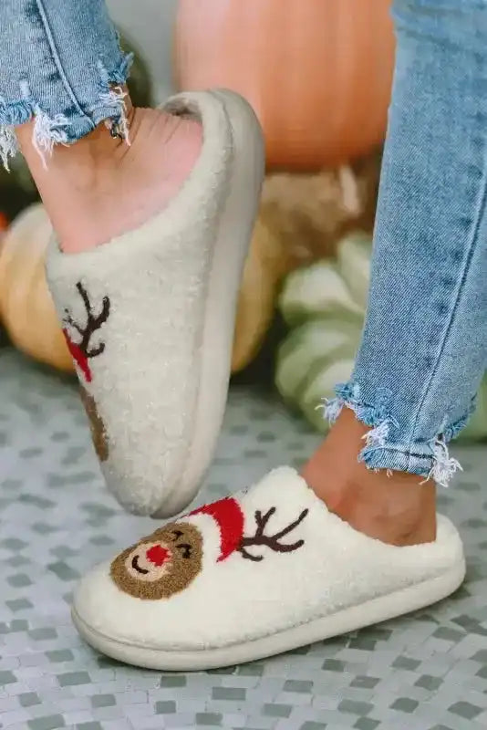 White Christmas deer slippers shown in motion, highlighting soft sole and cozy fleece material for winter home use.