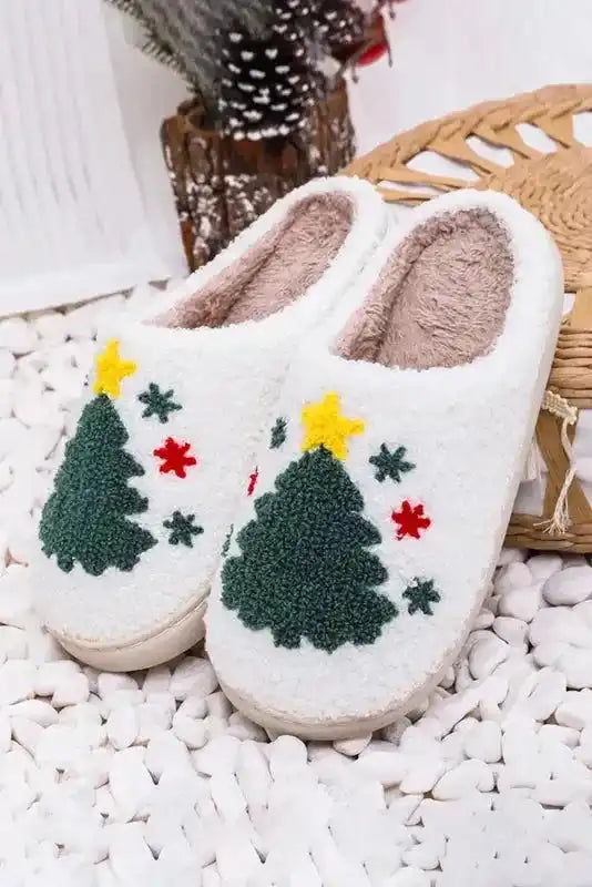 White fleece Christmas slippers with green tree and red star accents, soft lining ideal for winter home wear.