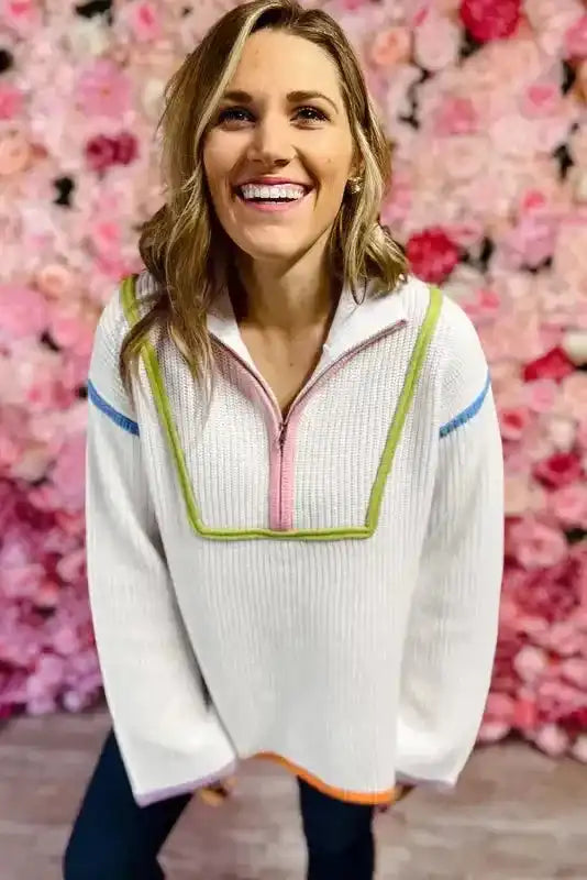 Front close-up of White Colorful Edge Sweater featuring pink zipper and green trim, ideal for stylish daily winter wear.