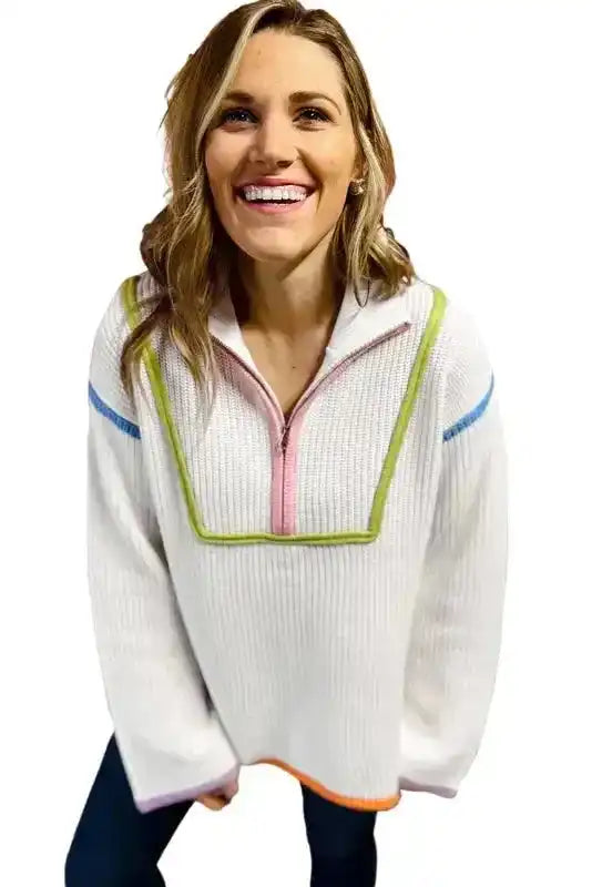 Isolated view of White Colorful Edge Sweater with quarter zip and vibrant color-blocked trim, great for trendy seasonal layering.