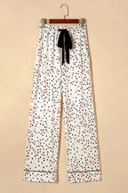 White Star Panel Pyjama Set pants displayed on hanger with black ribbon tie and star pattern. Stylish and soft women’s sleepwear trousers.