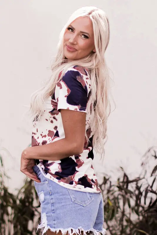 Woman with long platinum blonde hair in cow pattern print shirt enjoying relax relax