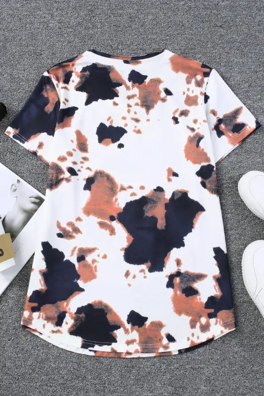 White cow pattern print short sleeve v neck t-shirt with abstract design in white, brown, black