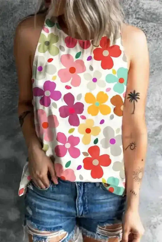 Model wearing sleeveless floral halter top paired with denim shorts in sunny outdoor setting