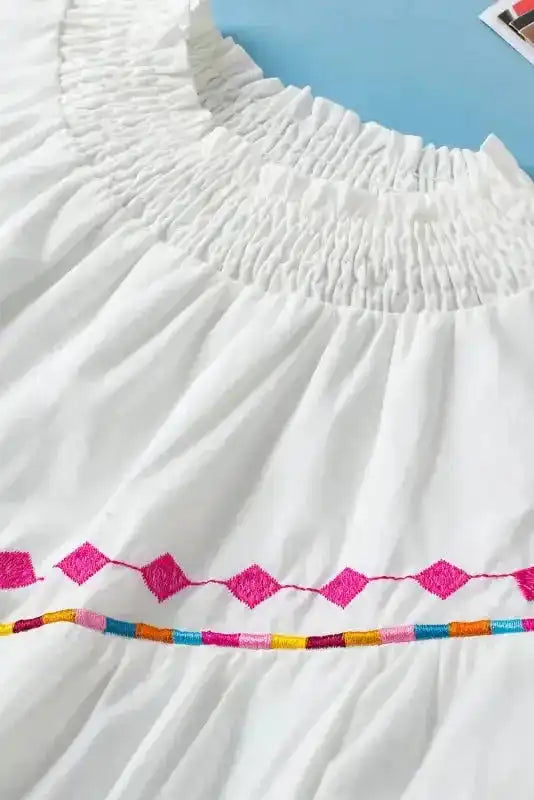 Close-up of White Embroidered Smocked Neck Puff Sleeve Blouse - Fashionfitz