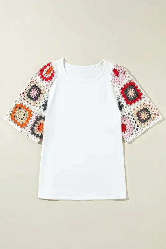 White short sleeve top with floral crochet detail laid flat on neutral background Fashionfitz