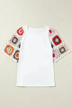 White short sleeve top with floral crochet detail laid flat on neutral background Fashionfitz
