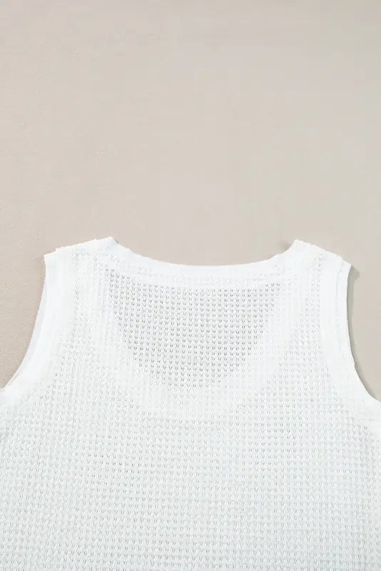 White flowy tunic tank top: white sleeveless knit top with a textured pattern