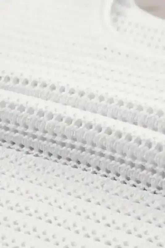 Detailed close-up of White Knit Tee fabric showing intricate hollow-out crochet pattern for a lightweight, airy feel.