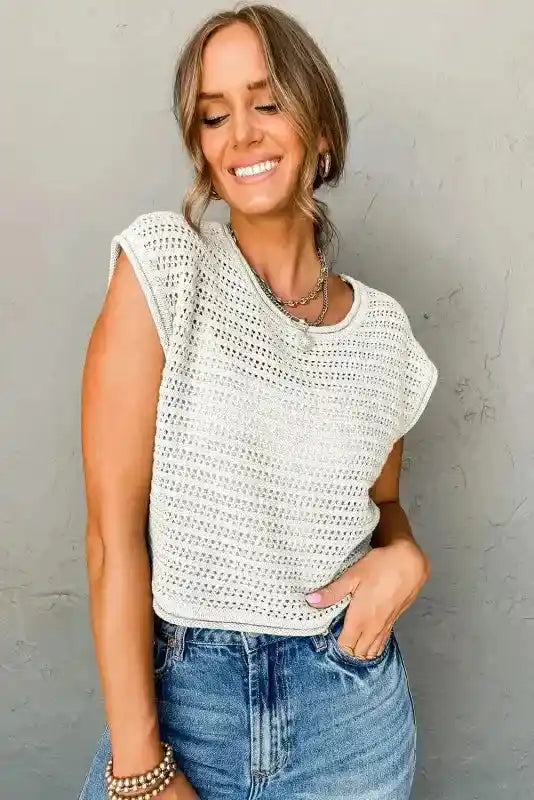 White Knit Cap Sleeve Tee styled casually with jeans, featuring a round neck and breathable hollow-out crochet pattern.