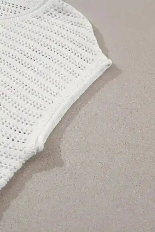 Cap sleeve detail of White Knit Tee showcasing the breathable hollow-out design and soft rolled edge for comfort.