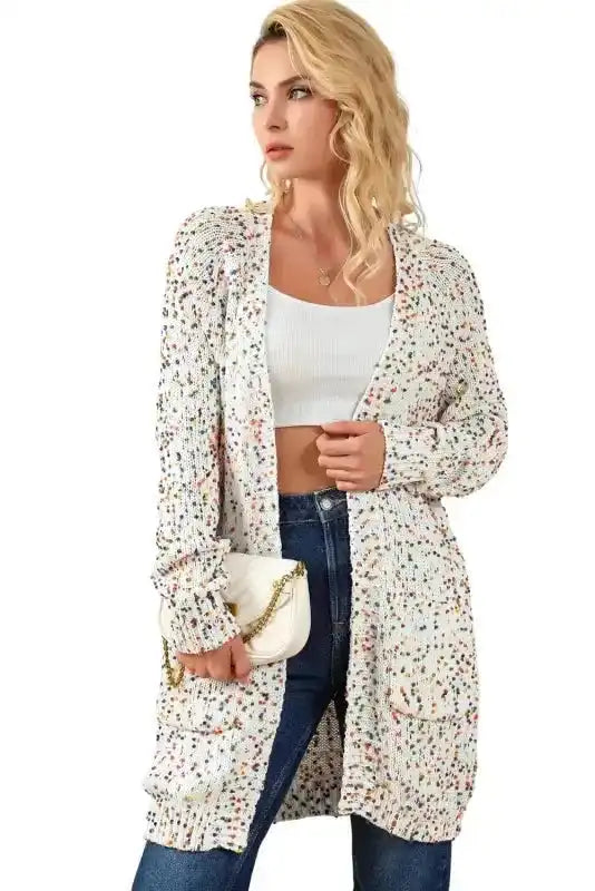 Model wearing New In White Pilling Detail Patterned Sleeve Sweater cardigan with gold chain purse, styled for a chic winter look.