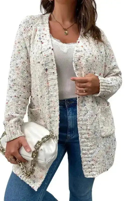 Studio shot of White Pilling Detail Patterned Sleeve Sweater cardigan on model with white background, highlighting knit texture and fit.