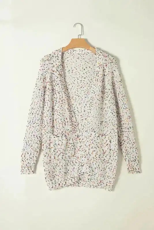 Flat lay of Patterned Sleeve White Sweater cardigan on hanger, showing open front and colorful speckled knit, perfect for daily wear.