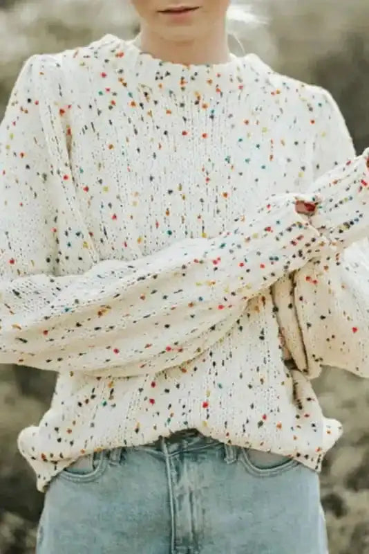 White Pilling Detail Patterned Sleeve Sweater with colorful speckles and puff sleeves, styled with light denim for a soft winter look.