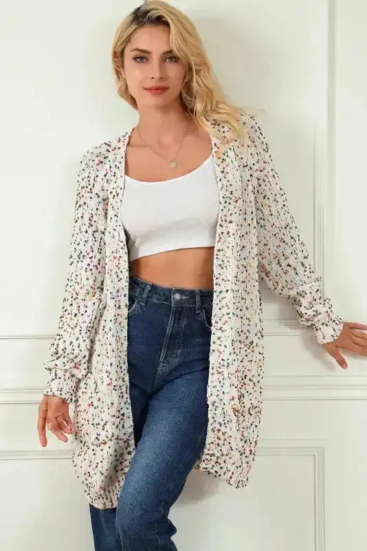 Model wearing White Pilling Detail Patterned Sleeve Sweater cardigan styled with jeans and crop top, showcasing its casual and chic appeal.