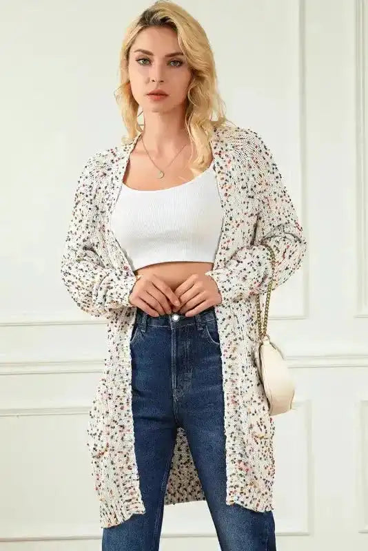 Model poses in New In White Pilling Detail Patterned Sleeve Sweater cardigan, showing its open front and colorful speckled knit design.