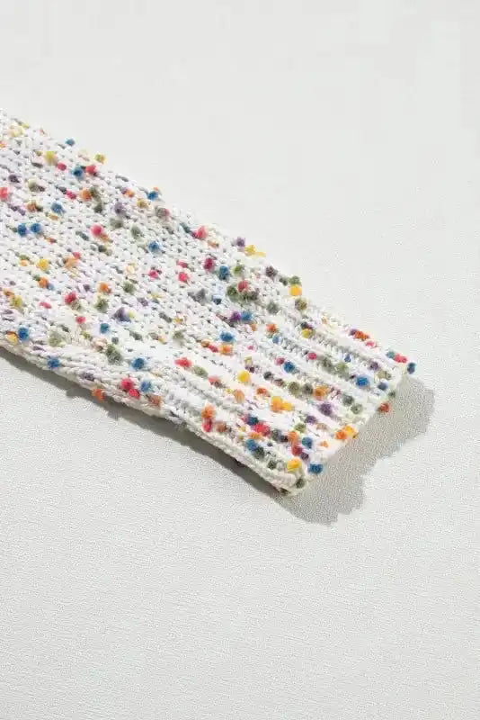 Close-up of patterned sleeve on White Pilling Detail Sweater featuring multicolor pilling for a playful, stylish winter top.