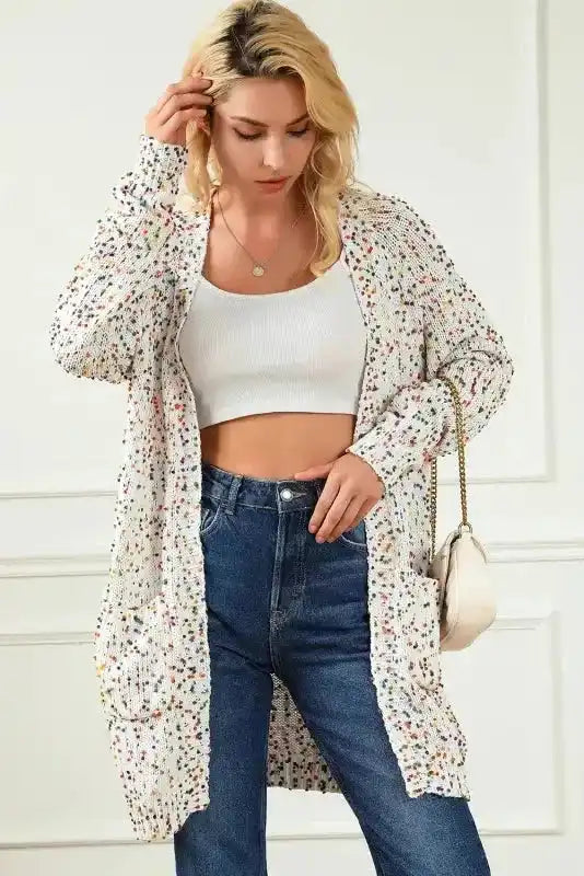 White Pilling Detail Patterned Sleeve Sweater cardigan styled with a white crop top and jeans, highlighting its lightweight and comfy fit.