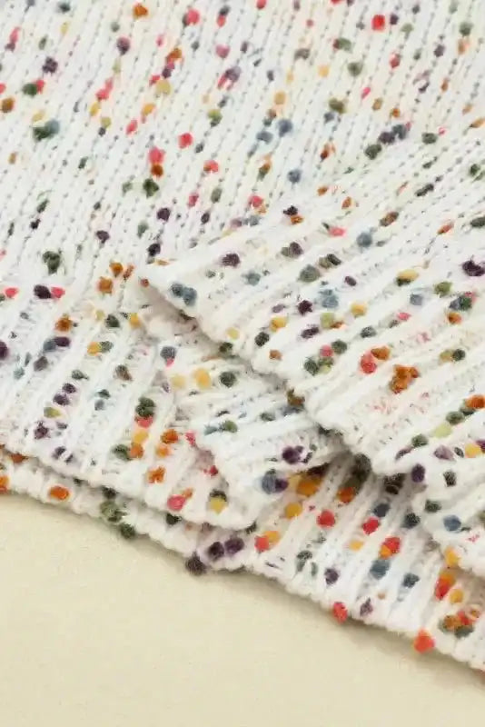 Close-up of hem and sleeve texture on White Pilling Detail Patterned Sleeve Sweater with vibrant speckled knit.