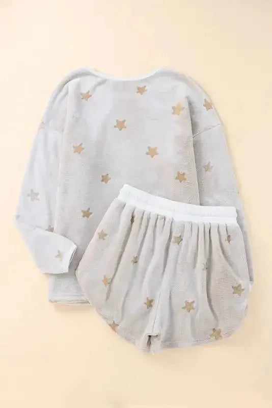 White plush lounge set featuring a star-patterned top and matching shorts for comfy relaxation