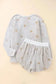 White plush lounge set featuring a star-patterned top and matching shorts for comfy relaxation