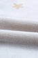 Close-up of soft fabric showing white plush lounge set with a cozy texture and star detail