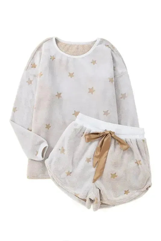 White plush lounge set featuring a star-patterned top and matching shorts with a bow detail