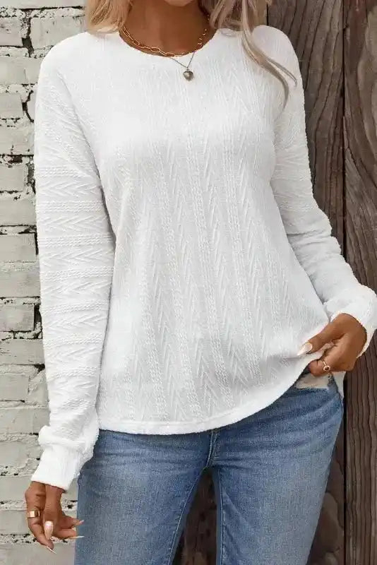 Front view of White Round Neck Drop Shoulder Textured Knit Top - Long featuring ribbed texture and long sleeves, paired with denim jeans.