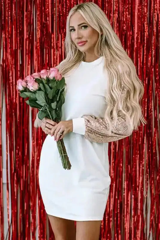 White Sequin Puff Sleeve Mini Dress styled for a festive look, featuring glittery sleeves and a flattering shift fit.
