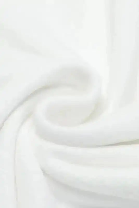 Close-up of soft white fabric used in the White Sequin Puff Sleeve Dress, highlighting its cozy texture and quality.