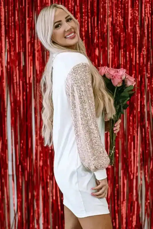 Side profile of White Sequin Puff Sleeve Dress with shimmering sleeves, styled for a festive or elegant winter look.