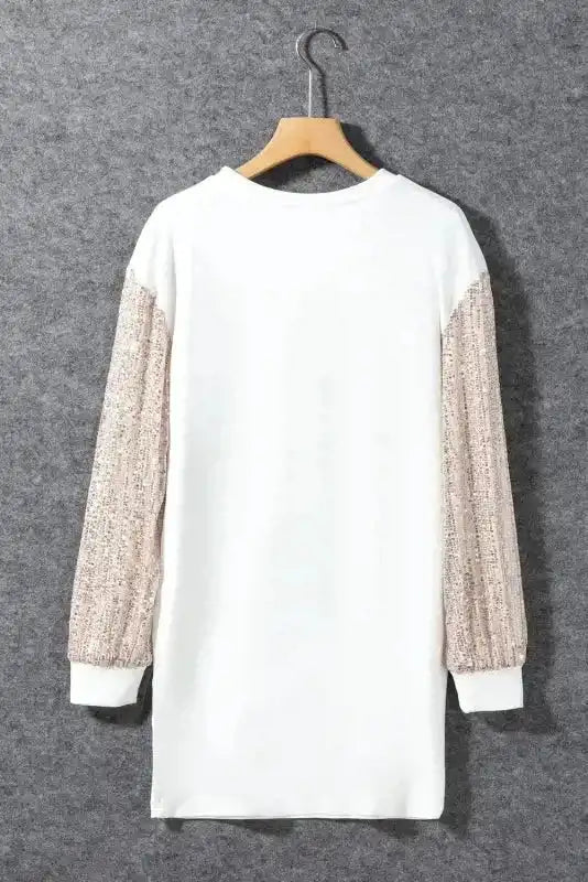 Back view of White Sequin Puff Sleeve Dress on hanger, showing sequin sleeves and clean shift mini cut.