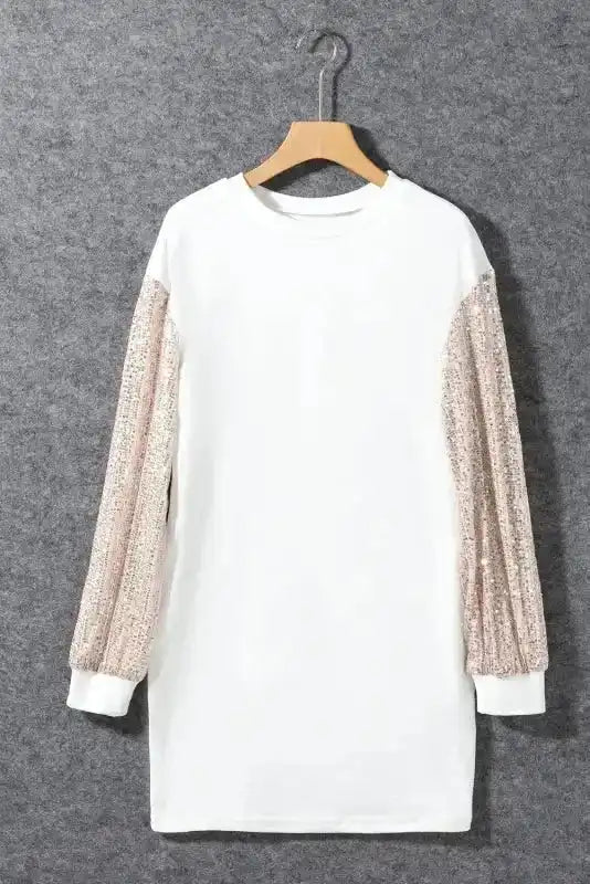 White Sequin Puff Sleeve Shift Mini Dress displayed on hanger, featuring shimmering sleeves and crew neckline.