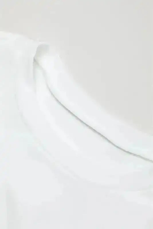 Neckline detail of White Sequin Puff Sleeve Dress with classic crew neck and soft white fabric finish.